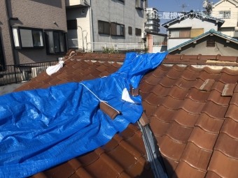 台風の強風で崩壊した棟をブルーシートでカバー