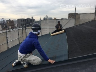 防水シートを敷く職人
