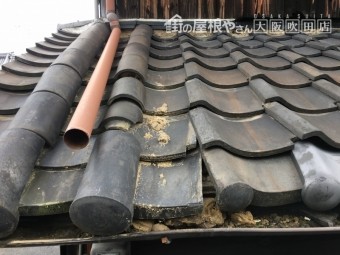 瓦の下の土が流れ出し歪みが生じている屋根。一部破損で落下の恐れがあり