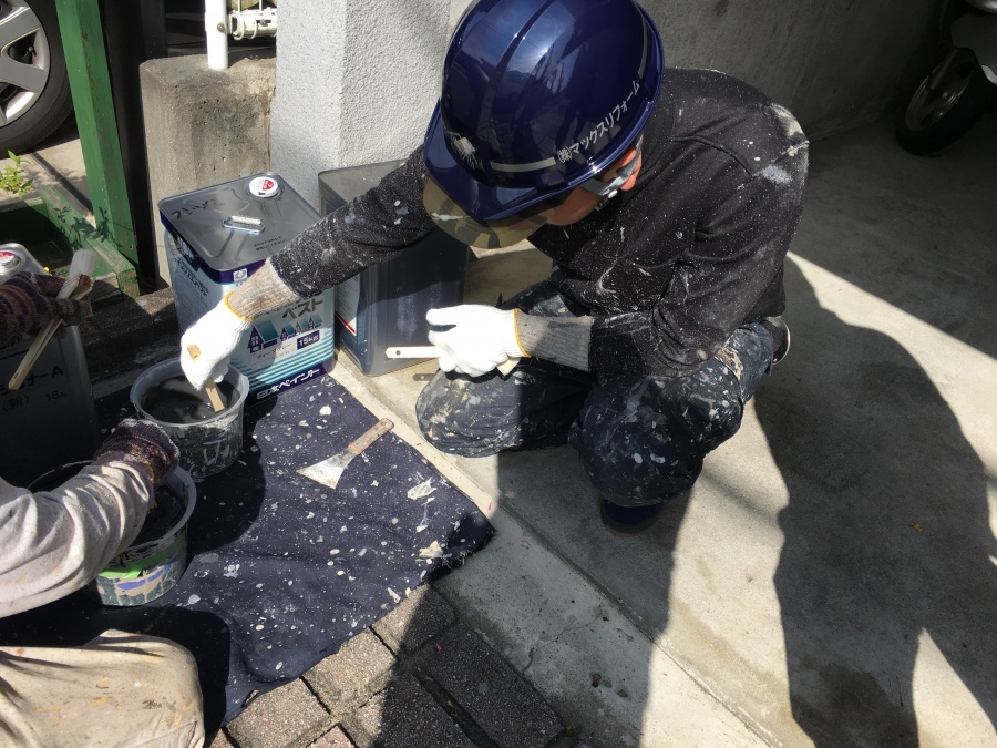 スレート屋根用塗料ファインシリコンベストを撹拌する職人