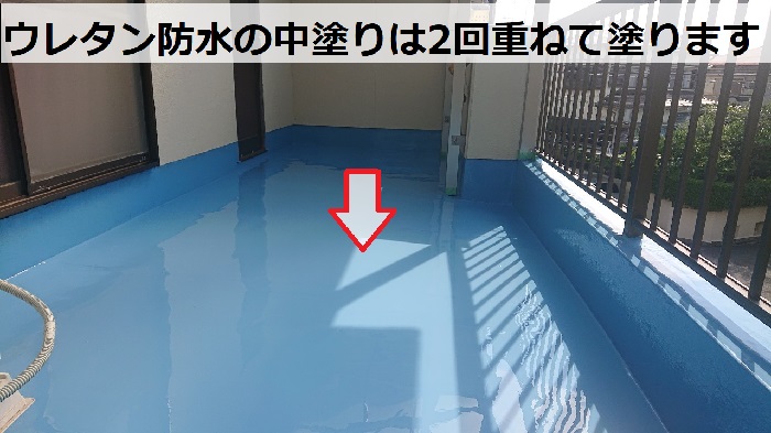 池田市でのウレタン防水工事で中塗りを行っている様子