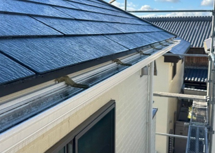 劣化により折れた樹脂製固定金具の軒樋をステンレス製の固定金具へ雨樋取り替えを行う前の様子