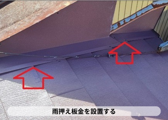 高槻市　　スレート屋根の壁際に雨押え板金を取りつけている様子