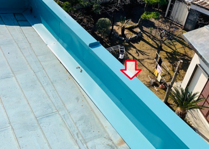 吹田市　ガルバリウム鋼板製の笠木をパラペット上部に取り付けている様子